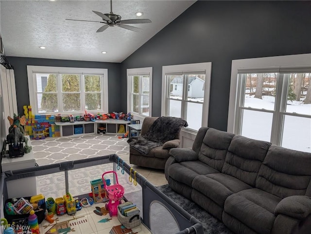 tiled living room with ceiling fan, plenty of natural light, lofted ceiling, and a textured ceiling