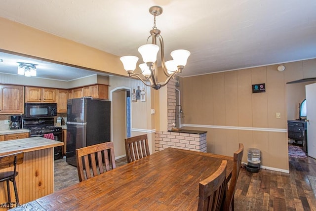 dining room with dark hardwood / wood-style floors and a chandelier