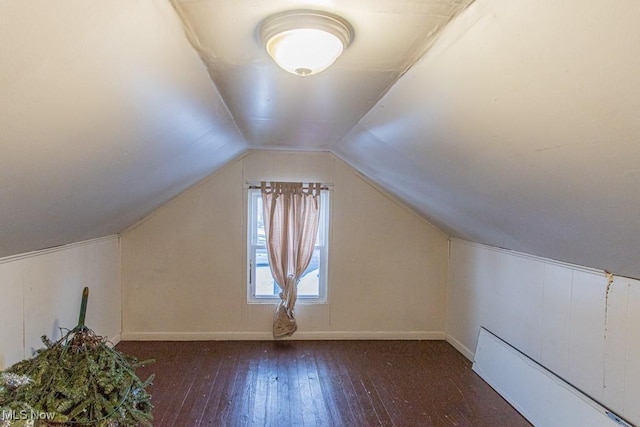 bonus room featuring dark wood-type flooring and lofted ceiling