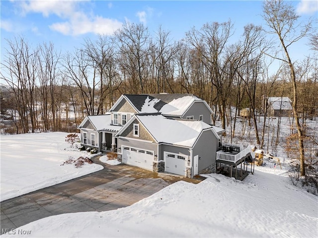 view of front of property featuring a garage and a wooden deck