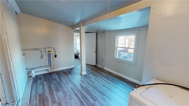 clothes washing area with wood-type flooring and washer / dryer