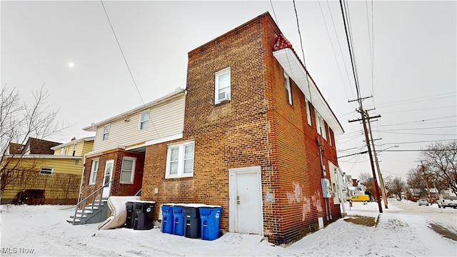 view of snow covered rear of property