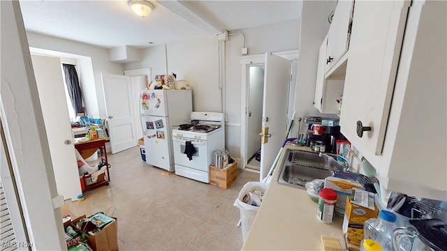 kitchen featuring sink, light tile patterned floors, white cabinets, and white appliances