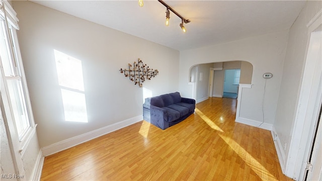 sitting room with hardwood / wood-style flooring and track lighting