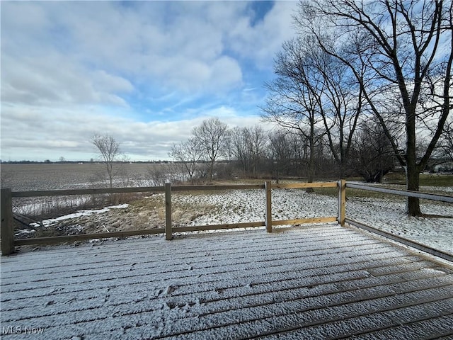 snow covered deck featuring a rural view