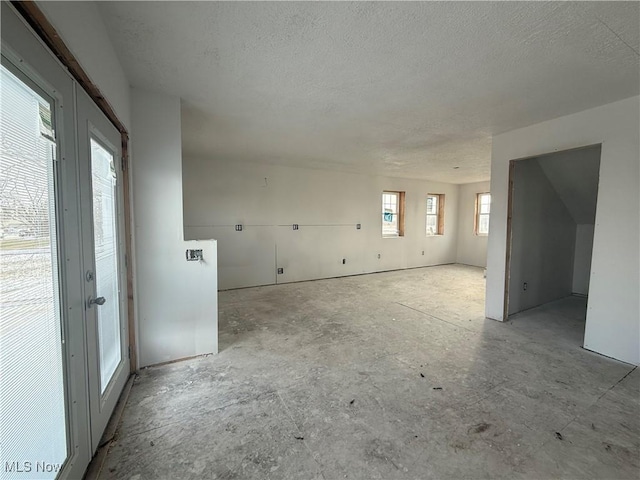 unfurnished living room featuring a textured ceiling