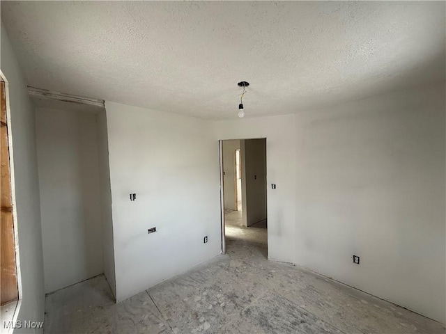 spare room featuring a textured ceiling