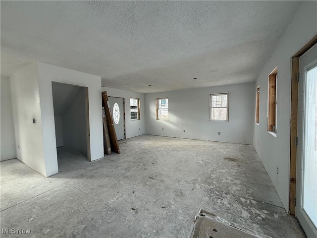 unfurnished living room with a textured ceiling