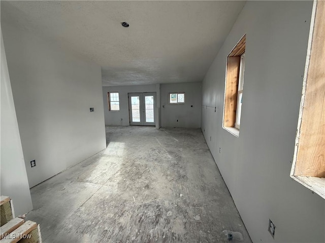 unfurnished living room featuring french doors