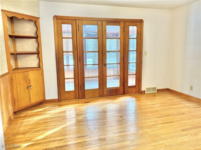 unfurnished room with light hardwood / wood-style floors