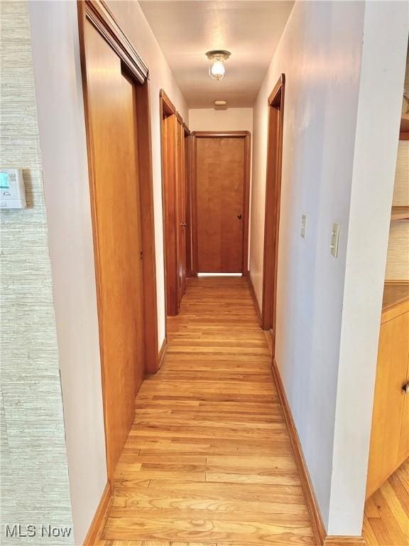 hallway with light hardwood / wood-style flooring