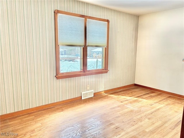 spare room featuring wood-type flooring