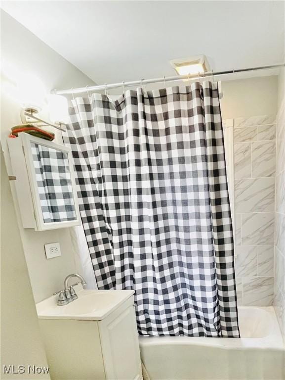 bathroom featuring sink and shower / bath combination with curtain