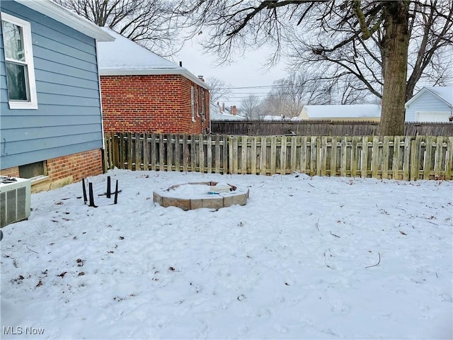 yard covered in snow with central AC unit