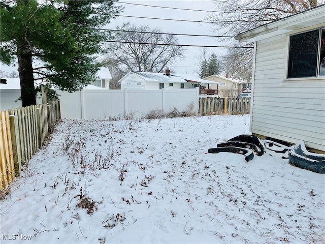 view of yard layered in snow