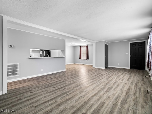 unfurnished living room featuring hardwood / wood-style floors and a textured ceiling