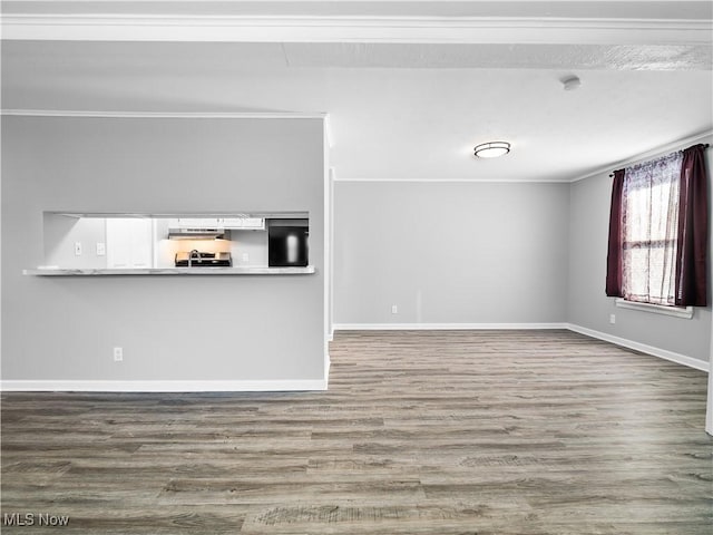 unfurnished living room with ornamental molding and hardwood / wood-style floors