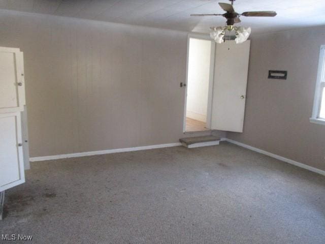 empty room featuring carpet floors and ceiling fan