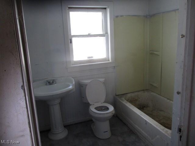 bathroom featuring a bathing tub and toilet