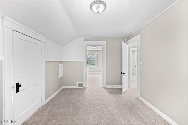 bonus room featuring light colored carpet and vaulted ceiling