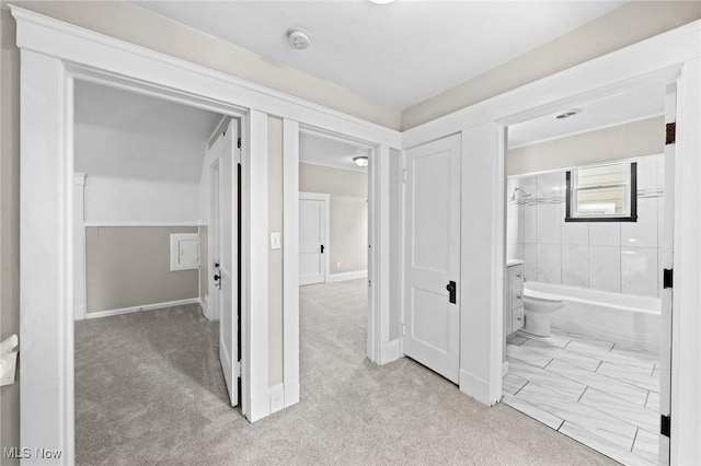 full bathroom with tiled shower / bath, vanity, and toilet