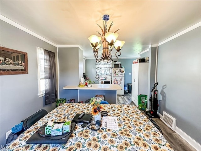 dining area with dark hardwood / wood-style flooring, crown molding, and a chandelier