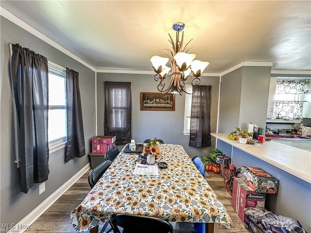 dining room featuring crown molding, dark wood-type flooring, and a chandelier