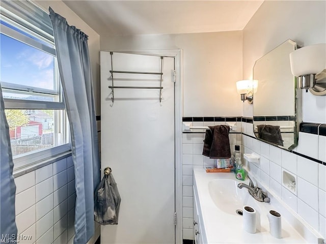 bathroom with tile walls and vanity