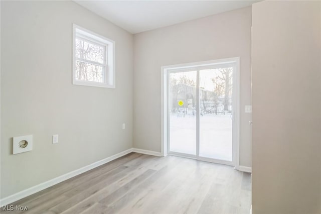 unfurnished room with a wealth of natural light and light hardwood / wood-style floors