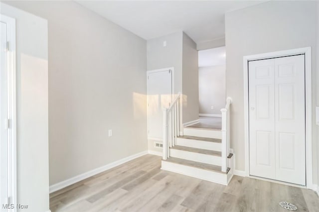 staircase with hardwood / wood-style flooring