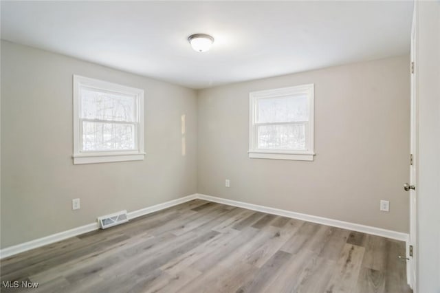 spare room featuring light wood-type flooring