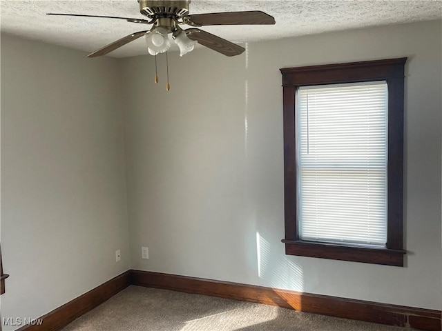 spare room with ceiling fan, carpet floors, and a textured ceiling