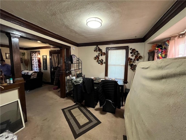 bedroom featuring crown molding, light colored carpet, and a textured ceiling