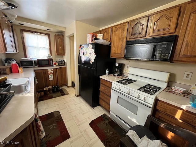 kitchen with sink and black appliances