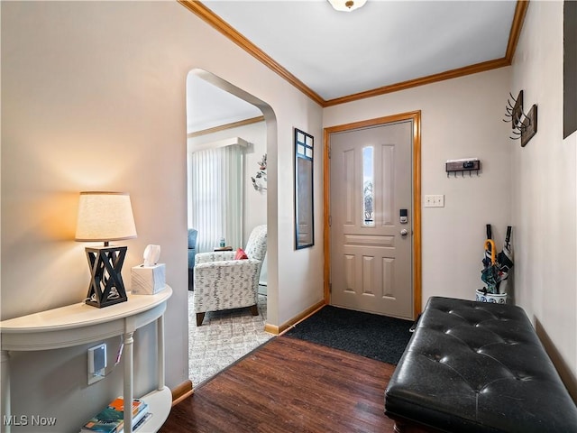 foyer entrance featuring crown molding and dark wood-type flooring