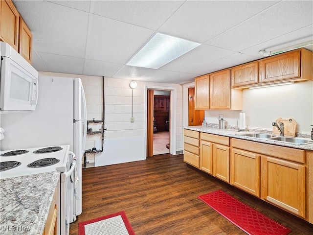 kitchen with a drop ceiling, sink, white appliances, and dark hardwood / wood-style floors