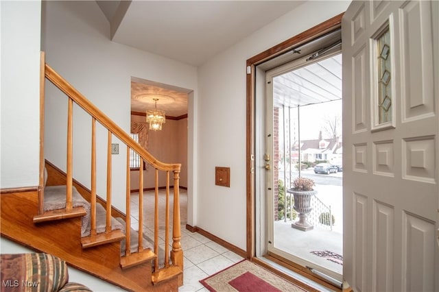 foyer featuring light tile patterned flooring and an inviting chandelier