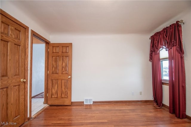 empty room with wood-type flooring