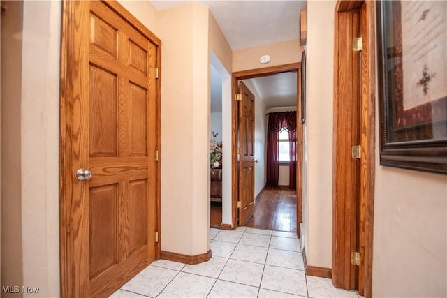 hall featuring light tile patterned flooring