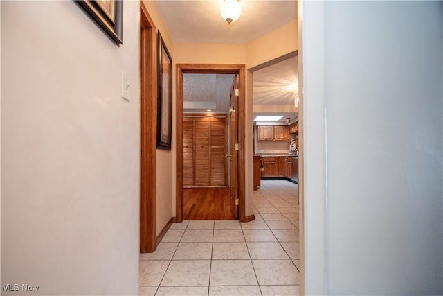 hall featuring light tile patterned floors