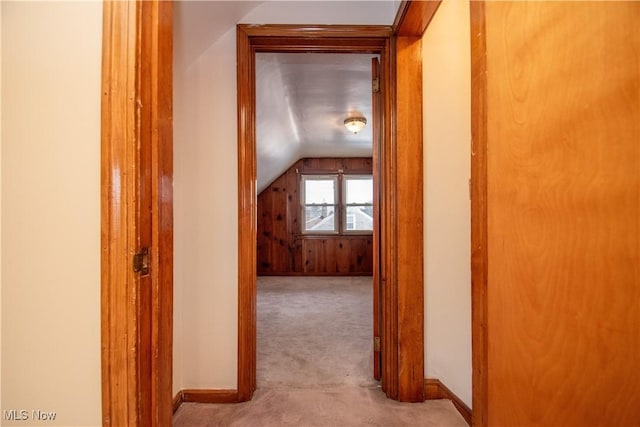 hall featuring light carpet and vaulted ceiling