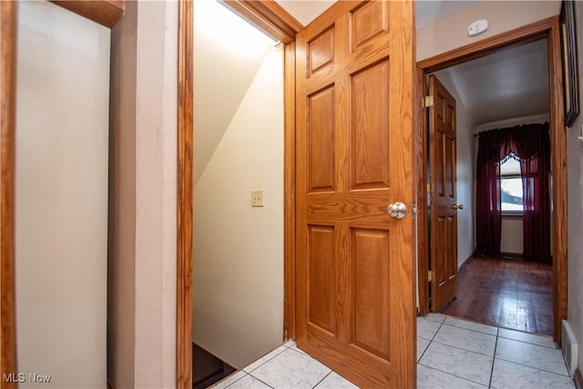 corridor featuring light tile patterned floors