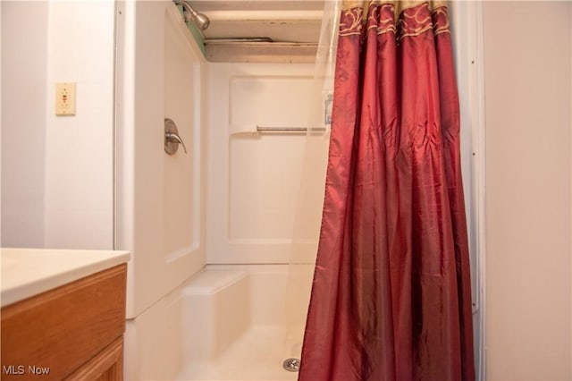 bathroom featuring vanity and curtained shower