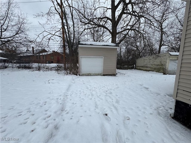 yard layered in snow with an outdoor structure