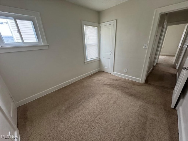 unfurnished bedroom featuring light carpet