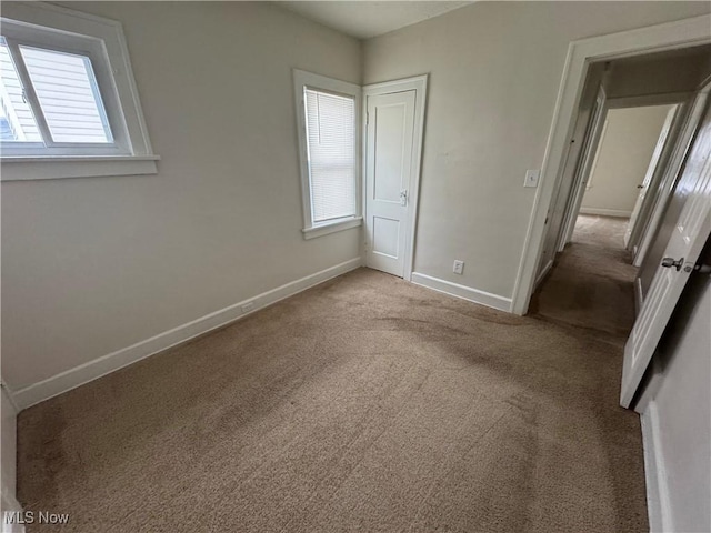 unfurnished bedroom with light carpet and a closet