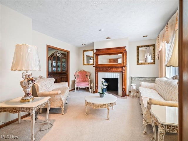 carpeted living room featuring a textured ceiling