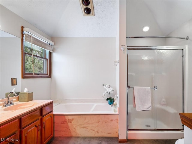 bathroom featuring lofted ceiling, separate shower and tub, and vanity