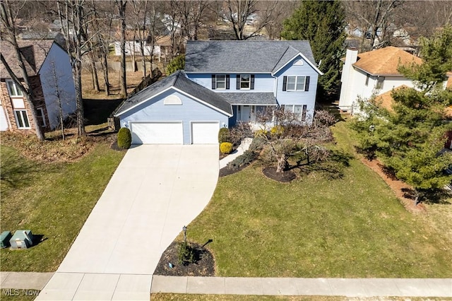 view of front of home featuring a front yard, an attached garage, and driveway