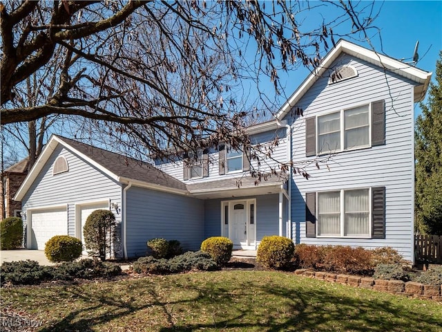 traditional-style home with a front yard, concrete driveway, and an attached garage